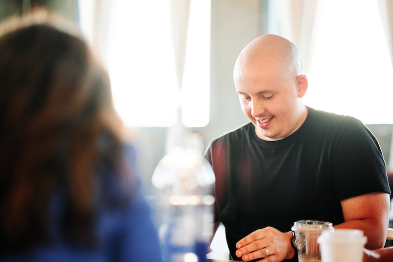 A photo of Garrett Jackson seated across from a team member while looking down at the table in front of him A photo of Garrett Jackson seated across from a team member while looking down at the table in front of him