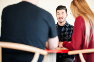 The Formada team building strategy includes playing games to learn and grow. Harrison Horblit, VP of Paid Media, smiles at a colleague.