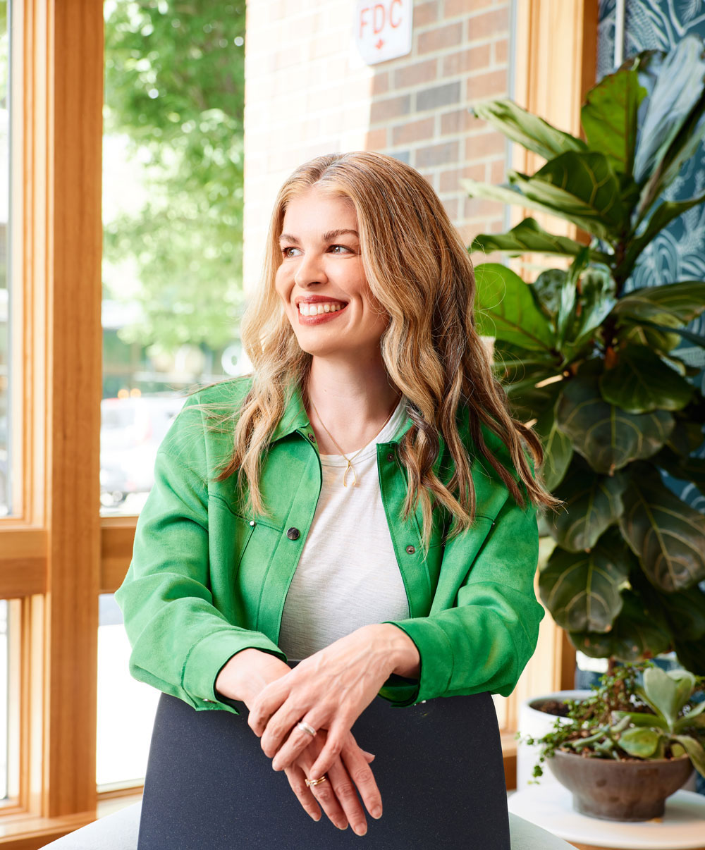Meghan Kelly, Co-founder and CEO, wearing a green jacket, smiles and looks to the left