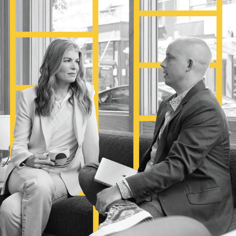 Formada Founders Meghan Kelly and Garrett Jackson are seated while discussing mission statement strategies. They are shot in black and white, facing each other. Yellow, ladder-like illustrations are drawn behind them in the image.