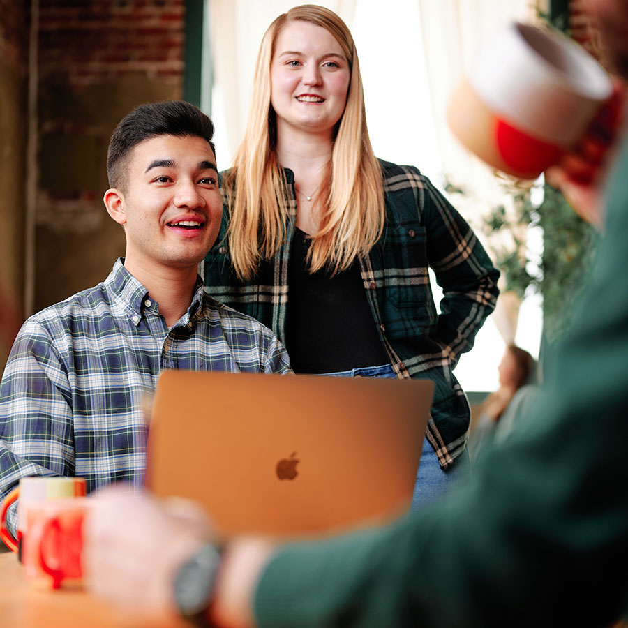 Harrison Horblit and Natalie Bufton of Formada sitting in front of a laptop talking to a client