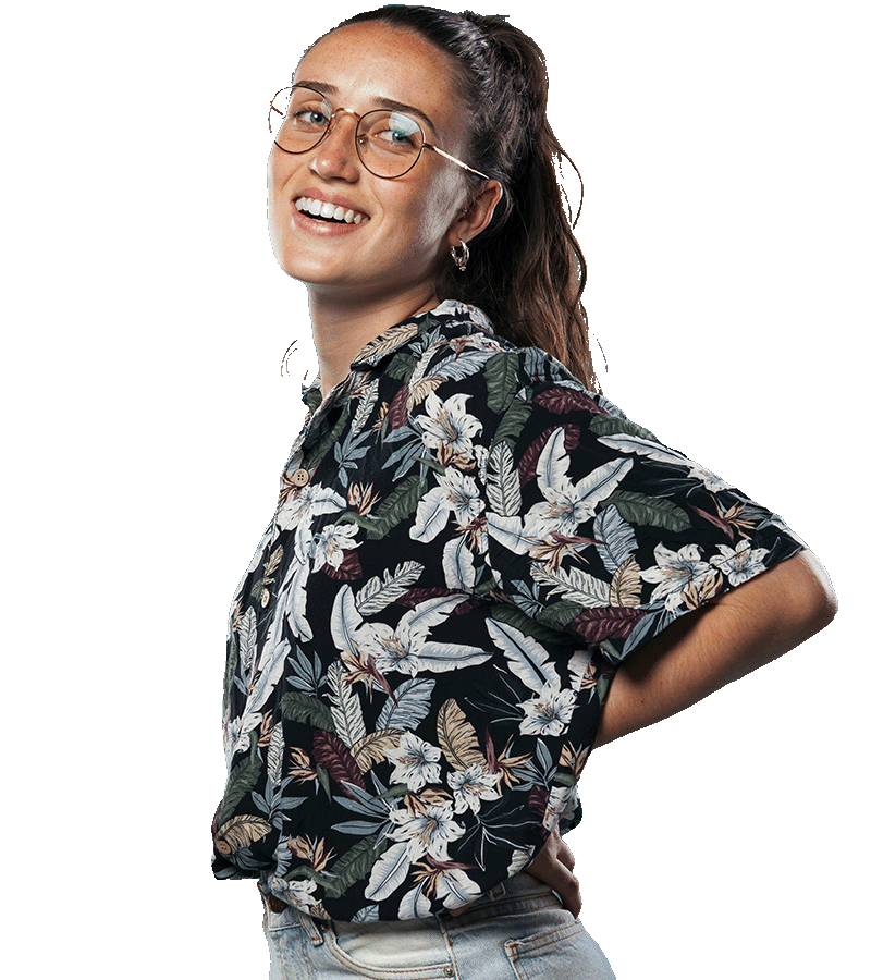 A young woman wearing glasses smiles