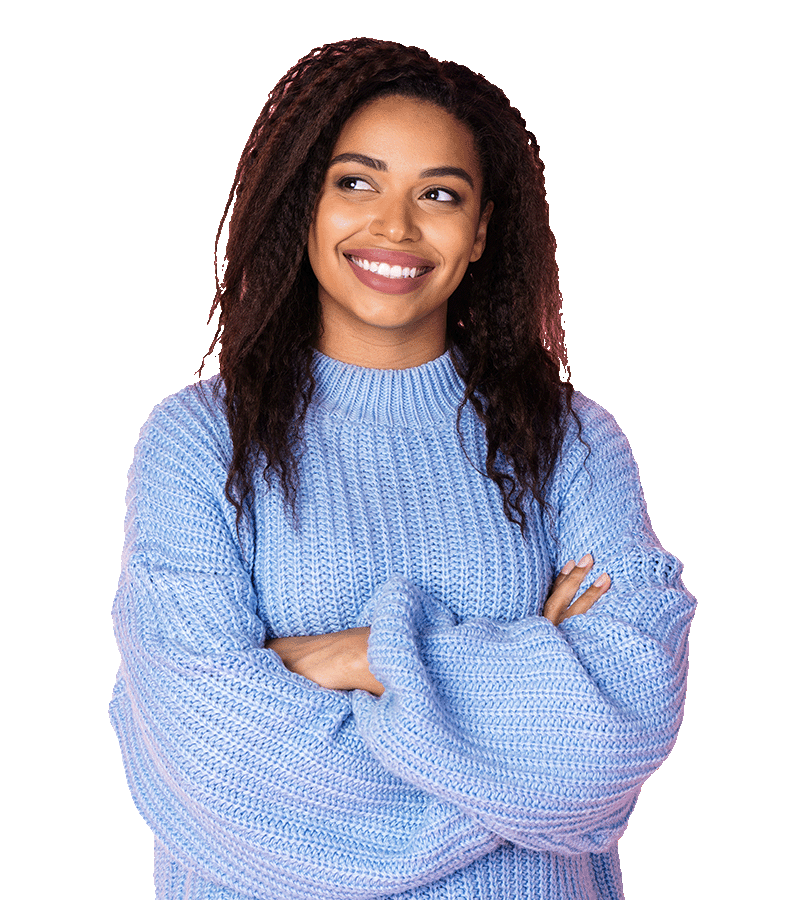 A young woman in a periwinkle sweater, smiles brightly while crossing her arms and glancing to her right.